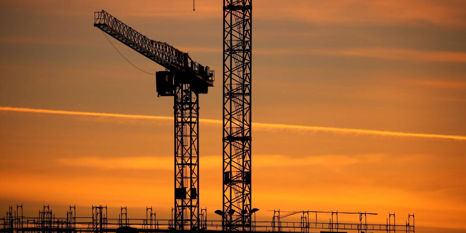 Baukräne einer Großbaustelle im Sonnenaufgang: Das Geschäftsklima verbesserte sich in allen betrachteten Wirtschaftsbereichen.