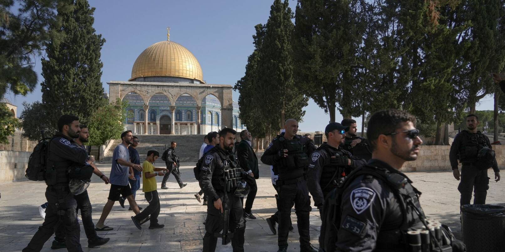 Israelische Polizisten eskortieren eine Gruppe jüdischer Männer zum Tempelberg in der Altstadt von Jerusalem - im Hintergrund die Al-Aqsa-Moschee.