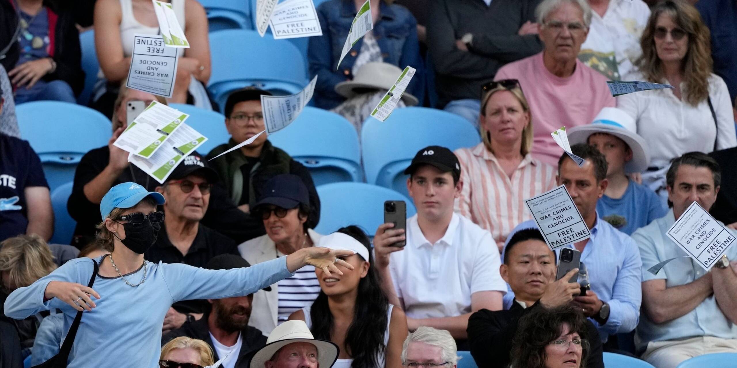 Eine Frau wirft während des Viertrundenmatches zwischen Alexander Zverev und Cameron Norrie bei den Australian Open in Melbourne Flugblätter mit der Aufschrift «Free Palestine» in die Luft.