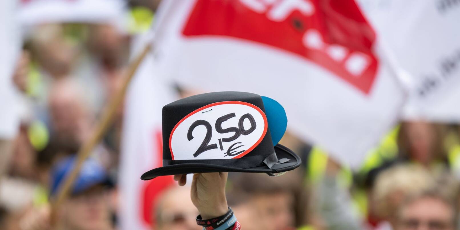 Ein Hut mit Sticker "2,50€" wird während der Kundgebung hochgehalten.